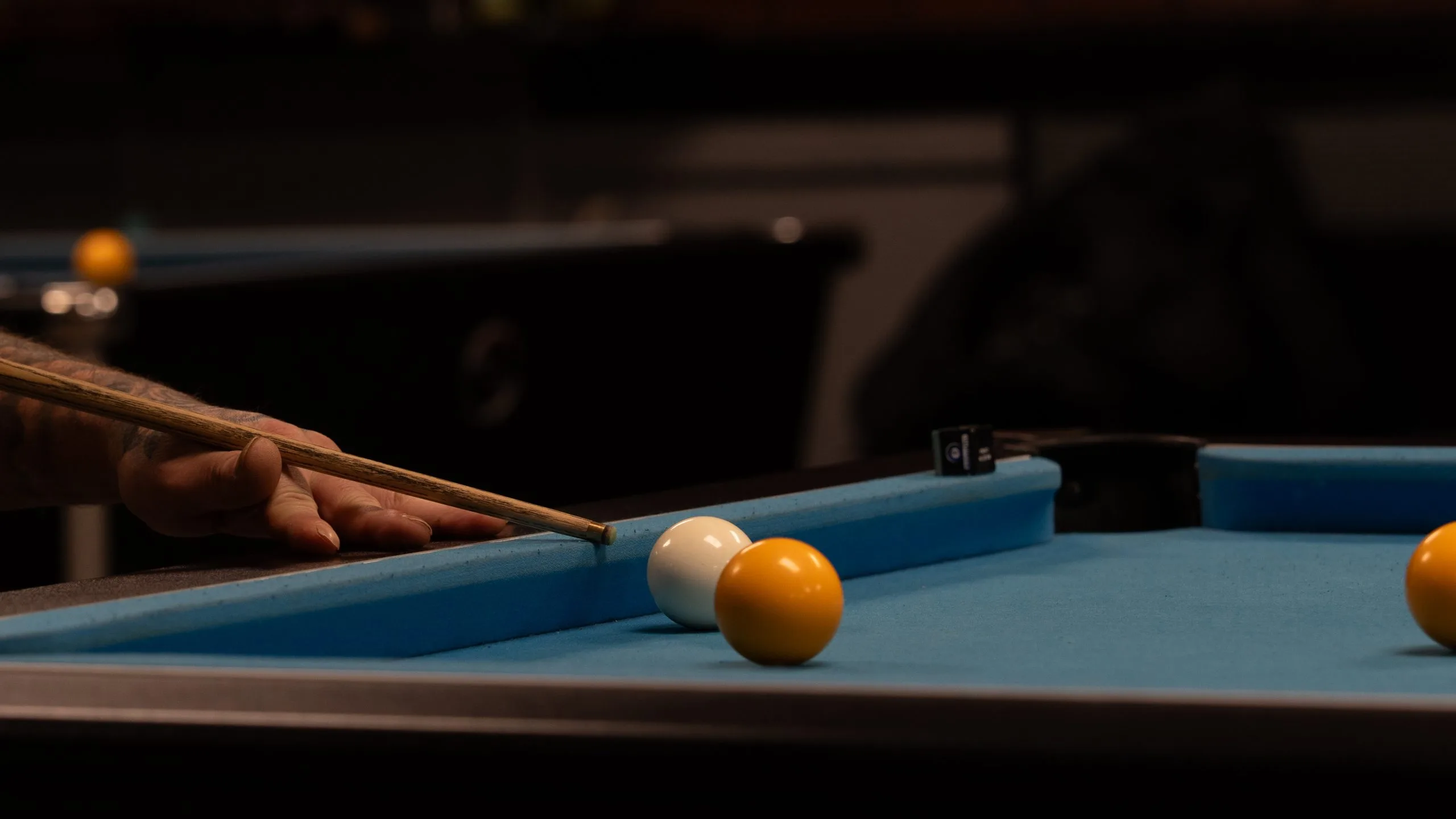 A pool shot lined up on one of the club's tables